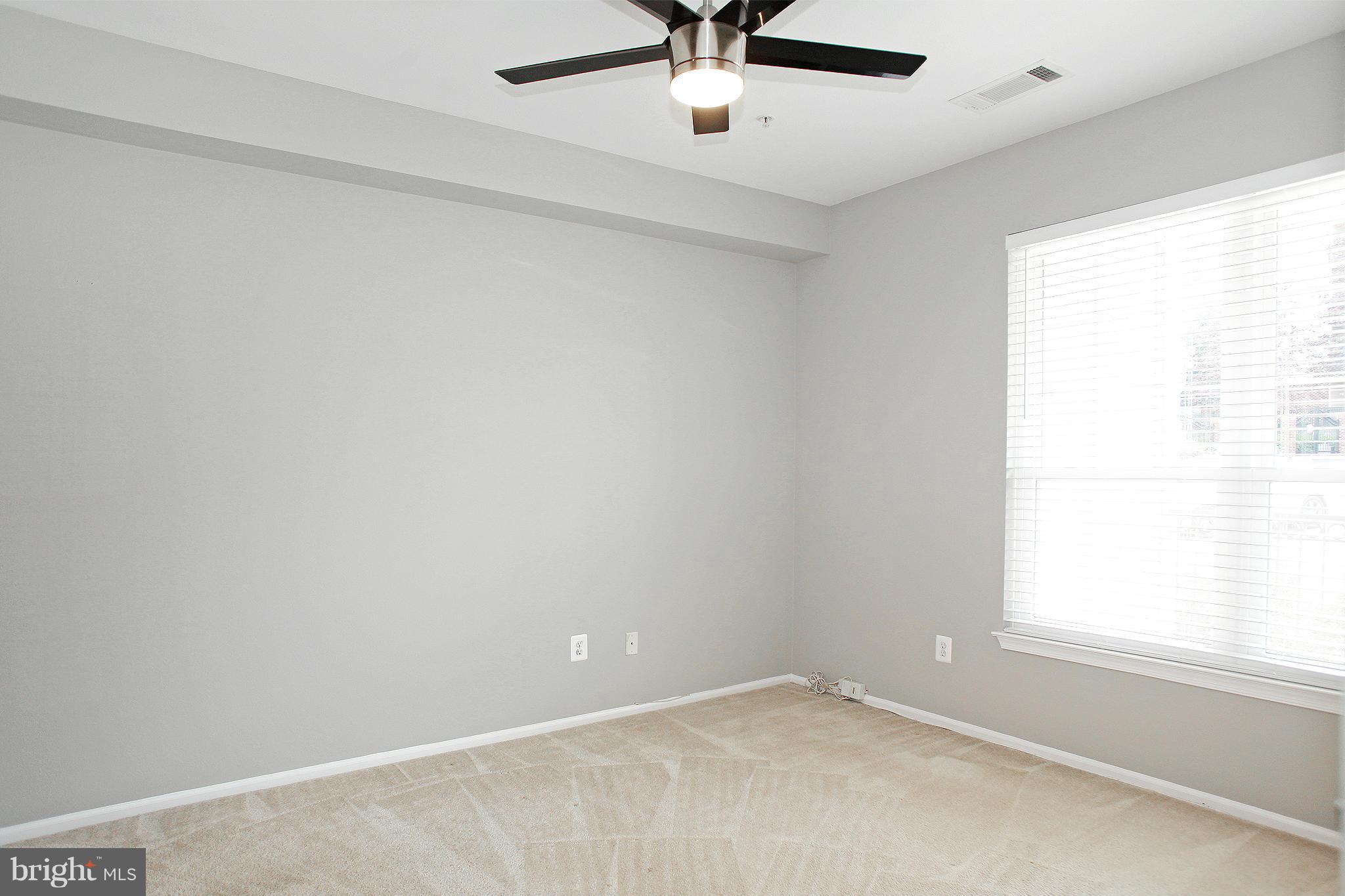 1530 Spring Gate Dr., Unit 9103 McLean, VA 22102 - Photo 10 of 30 an empty room with a window and a ceiling fan