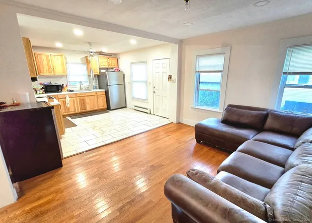 a living room with furniture and kitchen view