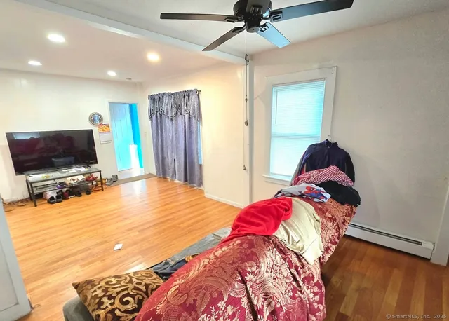 a bedroom with a bed and a flat screen tv