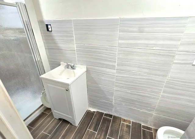 a bathroom with a sink toilet and shower