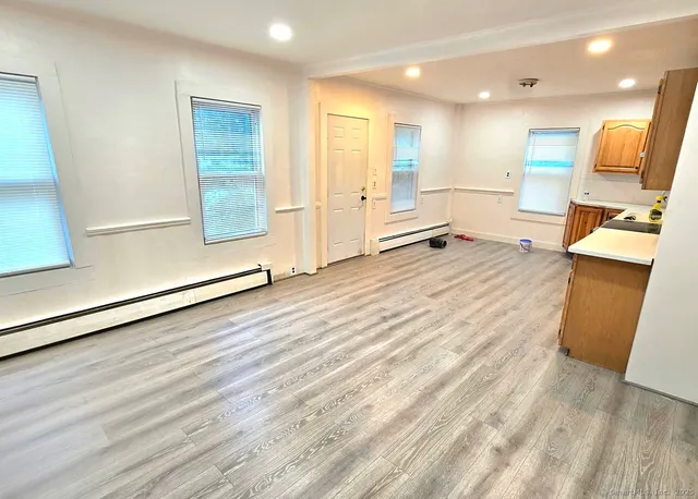 a view of a kitchen with a sink and a refrigerator