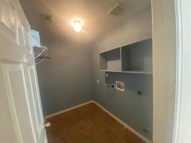 a view of storage and utility room with empty racks