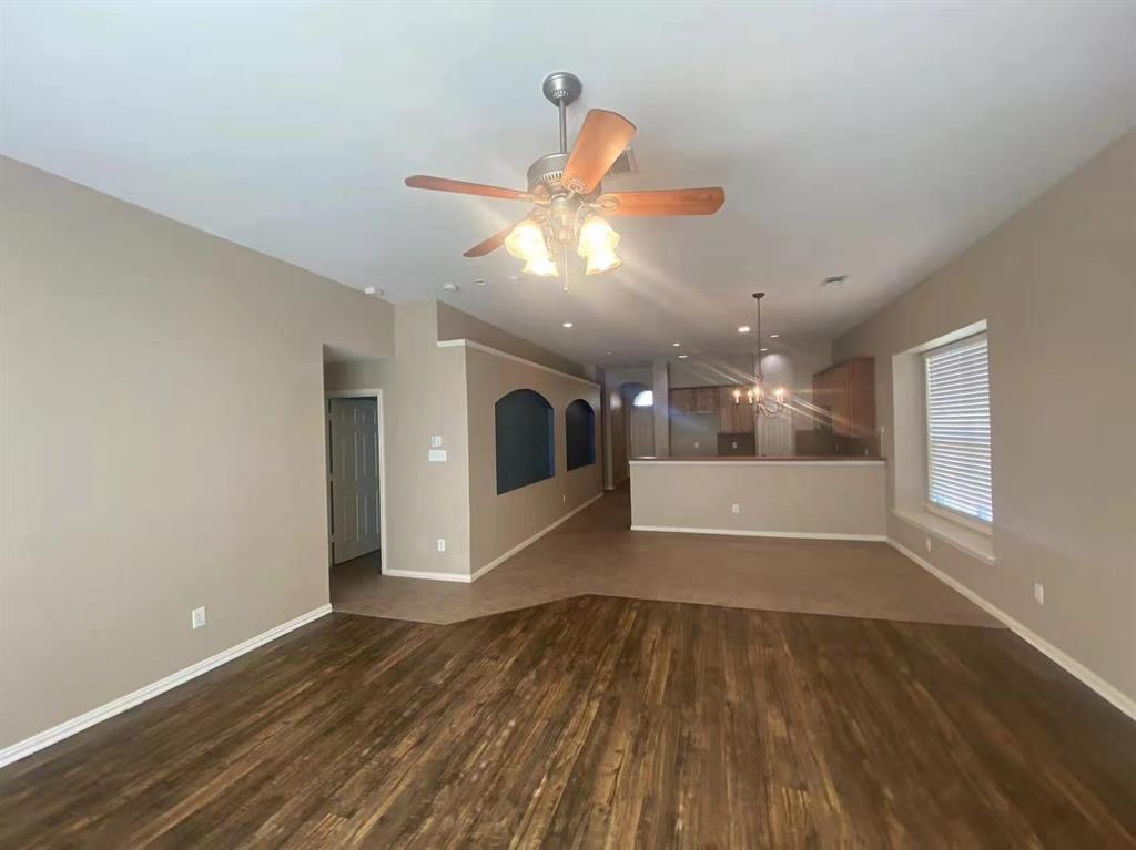 2363 Stuttgart Drive Frisco, TX 75033 - Photo 4 of 14 a view of an empty room with window and wooden floor