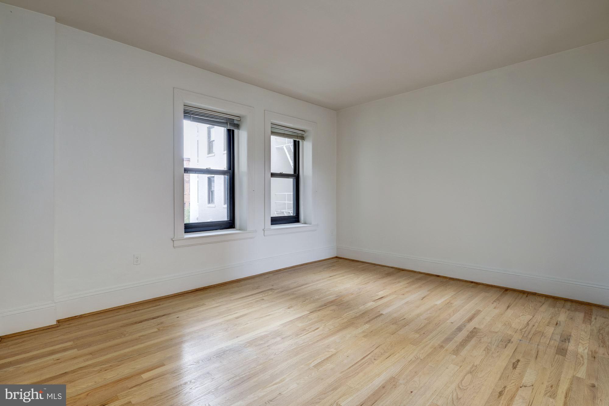 2153 California Street Northwest, Unit 306 Washington, DC 20008 - Photo 13 of 34 a view of an empty room with wooden floor and a window
