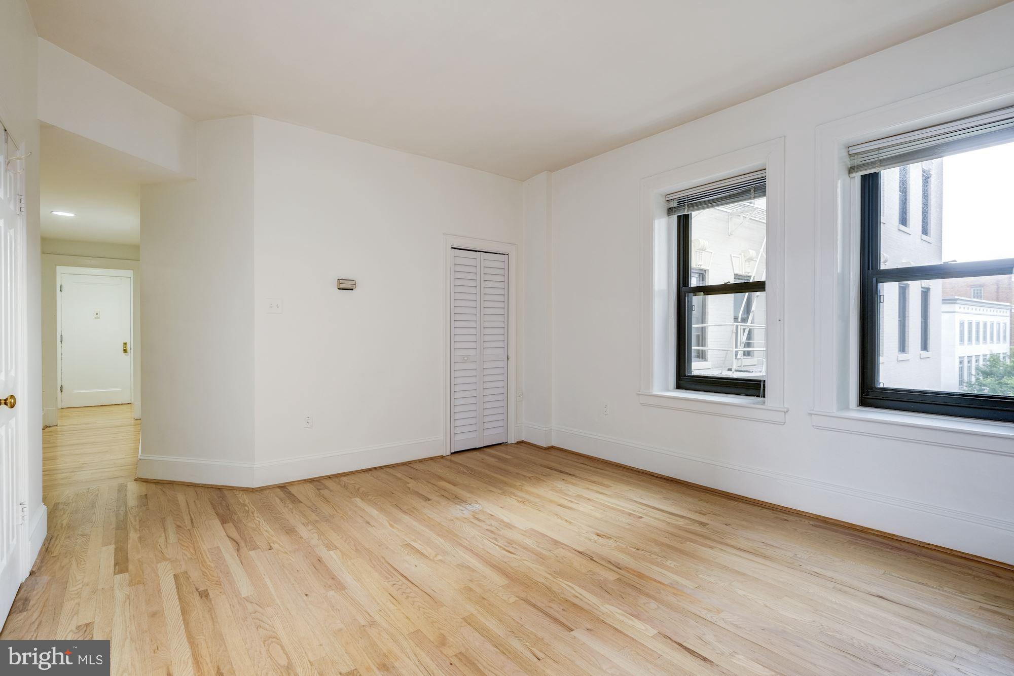 2153 California Street Northwest, Unit 306 Washington, DC 20008 - Photo 23 of 34 an empty room with wooden floor and windows