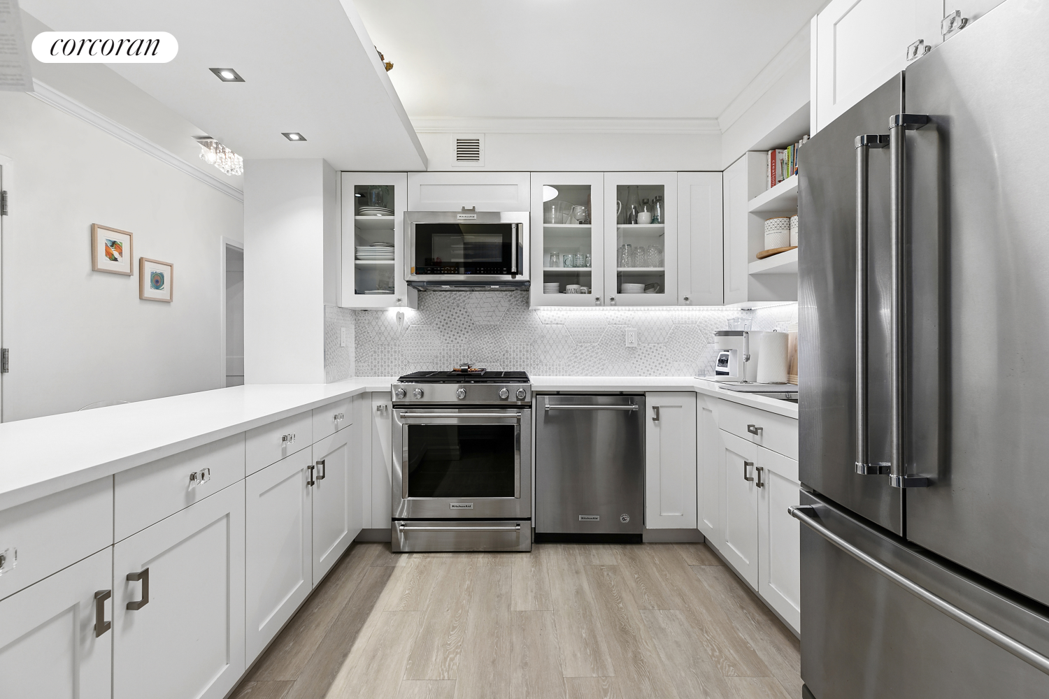 a kitchen with stainless steel appliances a sink stove and refrigerator