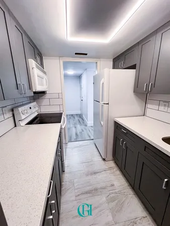 a kitchen with a sink and a refrigerator