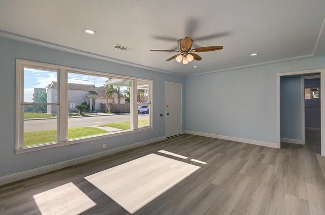 wooden floor in an empty room with a window