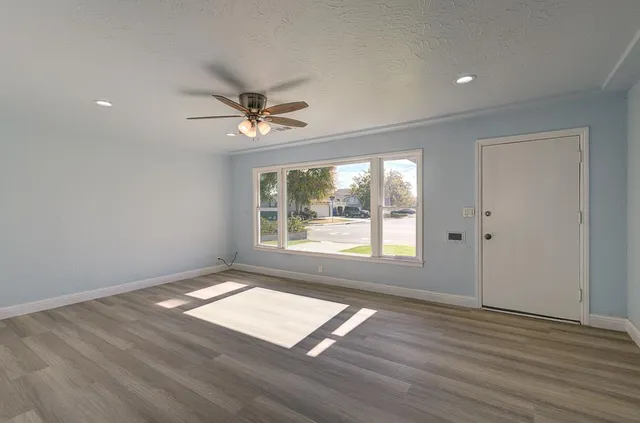wooden floor in an empty room with a window
