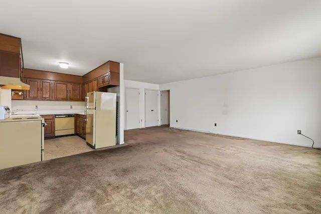 a view of a kitchen with a sink and a refrigerator