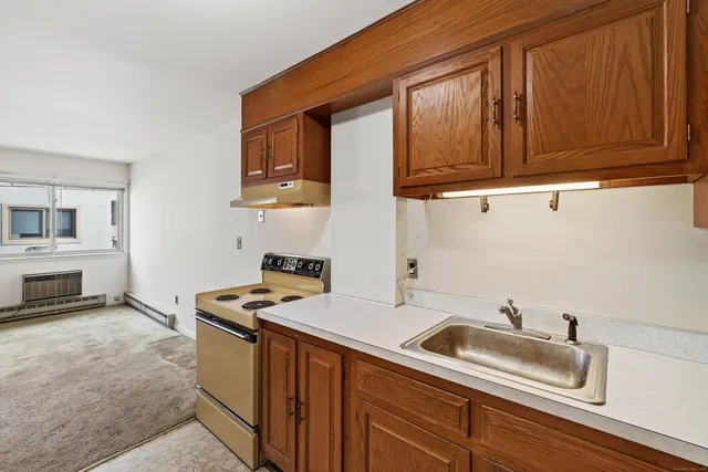 a kitchen with stainless steel appliances granite countertop a sink stove and microwave