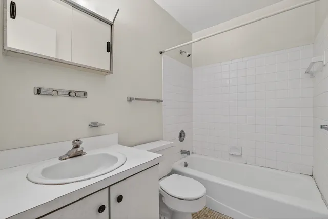 a bathroom with a sink a toilet and a bathtub