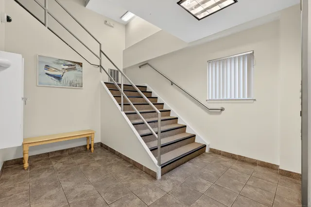 a view of a hallway with window and stairs