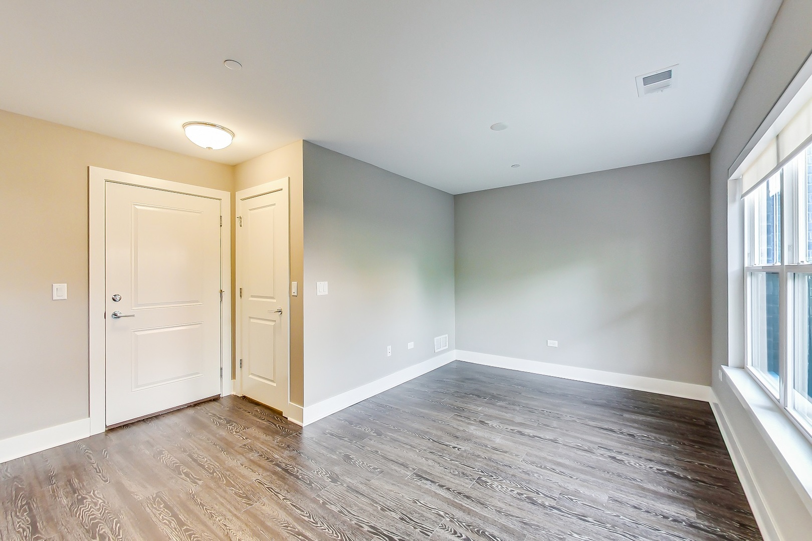 25 Clay Avenue, Unit E Highwood, IL 60040 - Photo 5 of 29 an empty room with wooden floor and windows
