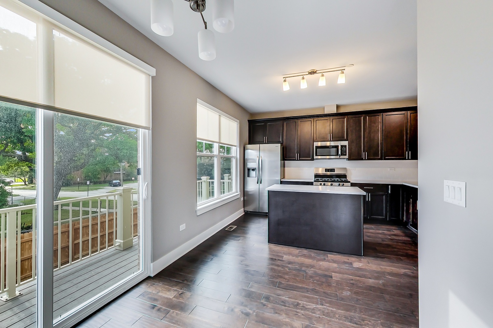 25 Clay Avenue, Unit E Highwood, IL 60040 - Photo 6 of 29 a view of kitchen with kitchen island wooden floor and stainless steel appliances