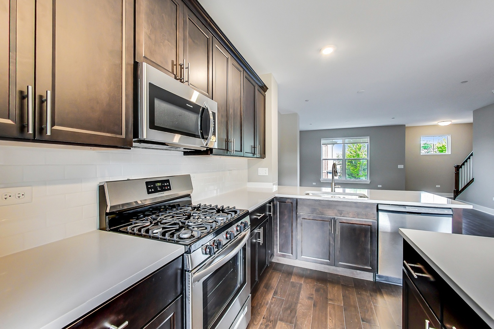 25 Clay Avenue, Unit E Highwood, IL 60040 - Photo 9 of 29 a kitchen with stainless steel appliances a stove microwave and sink