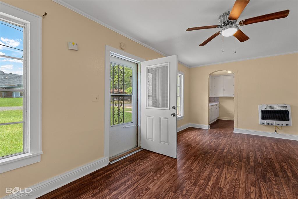 115 Pam Street Mansfield, LA 71052 - Photo 4 of 25 wooden floor in an empty room with a window