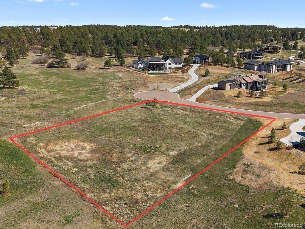 11491 Evening Hunt Road Franktown, CO 80116 - Photo 10 of 10 a view of a swimming pool with a table and chairs