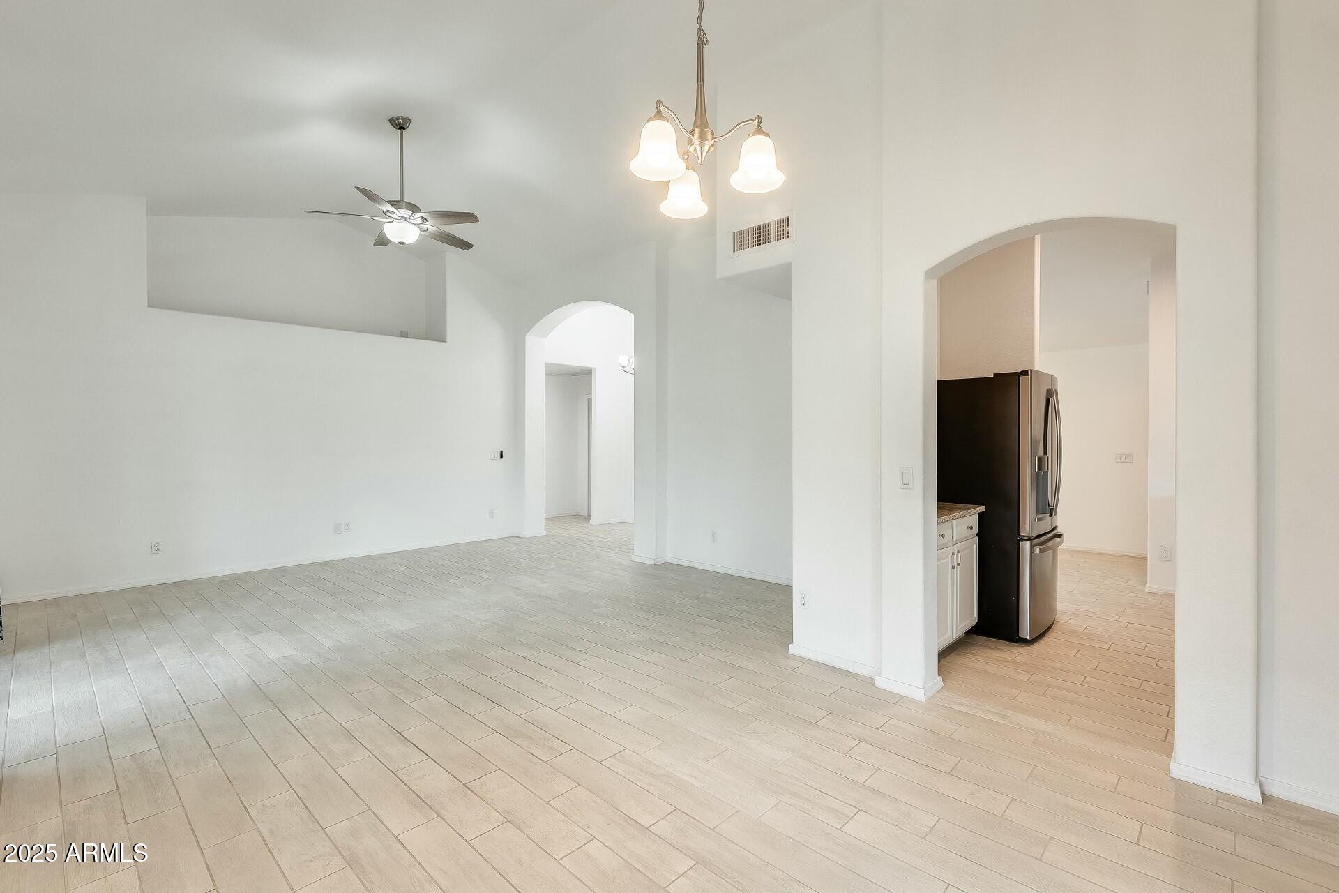 17514 North Rainbow Circle Surprise, AZ 85374 - Photo 13 of 69 a view of a room with a ceiling fan and refrigerator