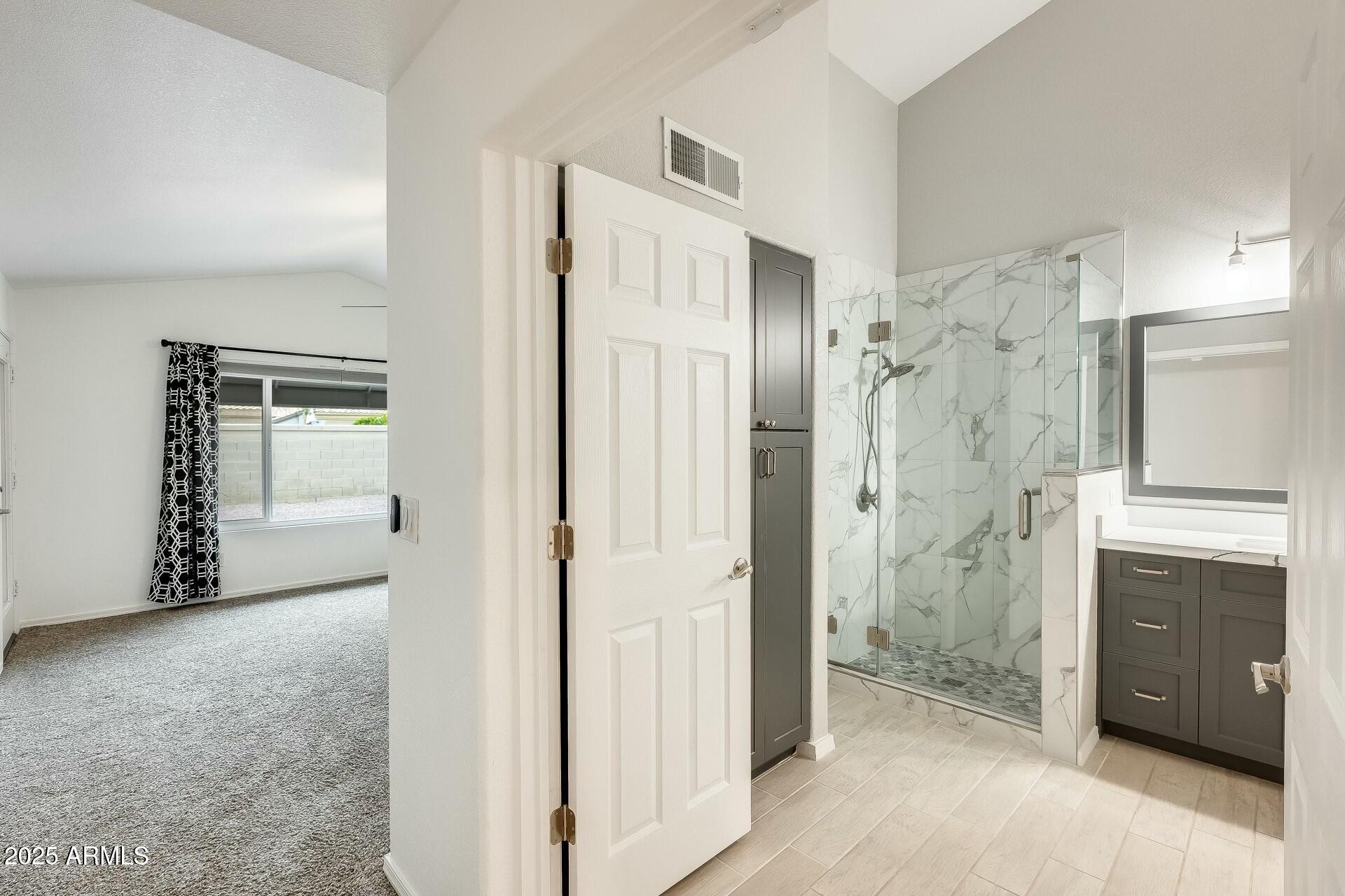 17514 North Rainbow Circle Surprise, AZ 85374 - Photo 26 of 69 a view of a bathroom with a shower and a sink