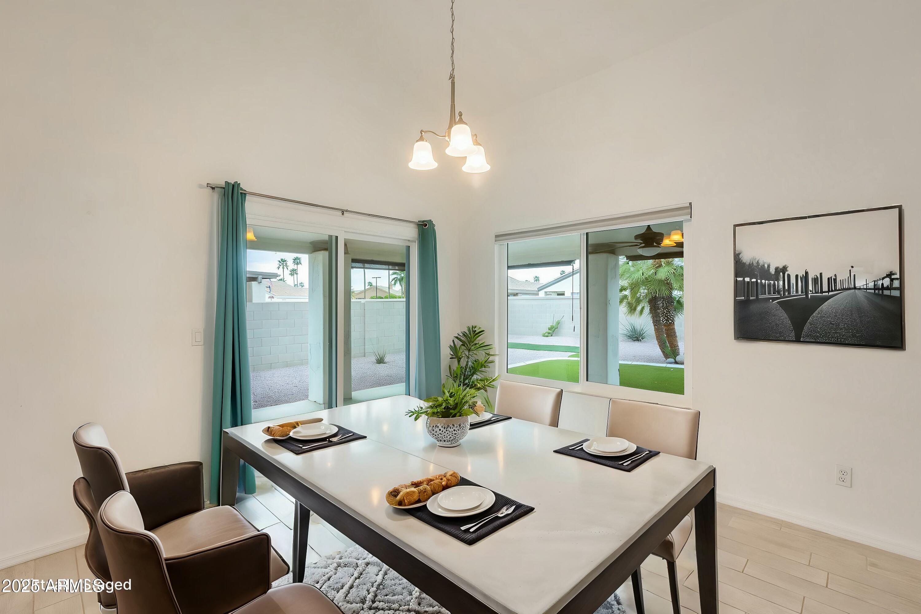 17514 North Rainbow Circle Surprise, AZ 85374 - Photo 3 of 69 a view of a dining room with furniture and a chandelier