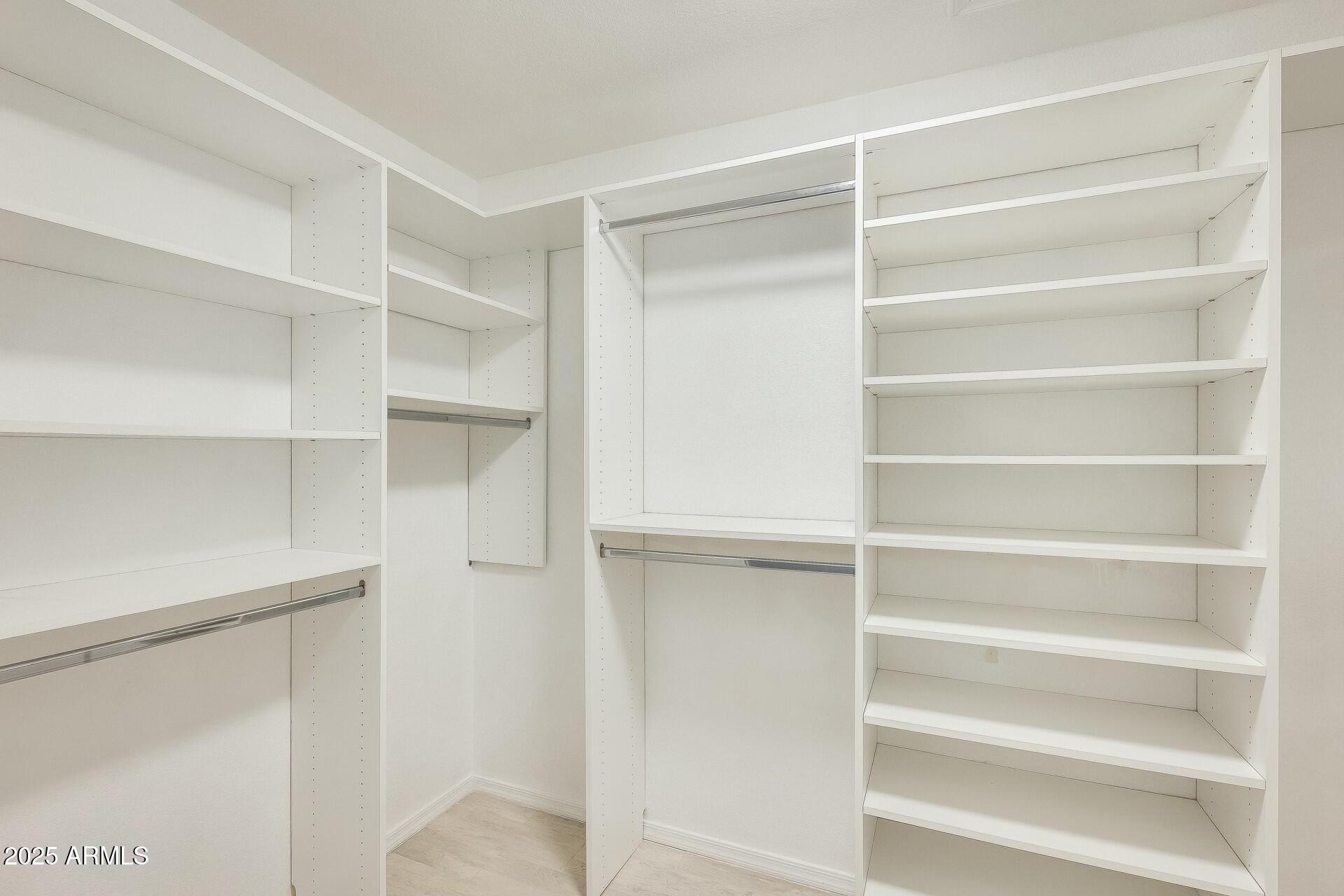 17514 North Rainbow Circle Surprise, AZ 85374 - Photo 32 of 69 a view of walk in closet with empty racks