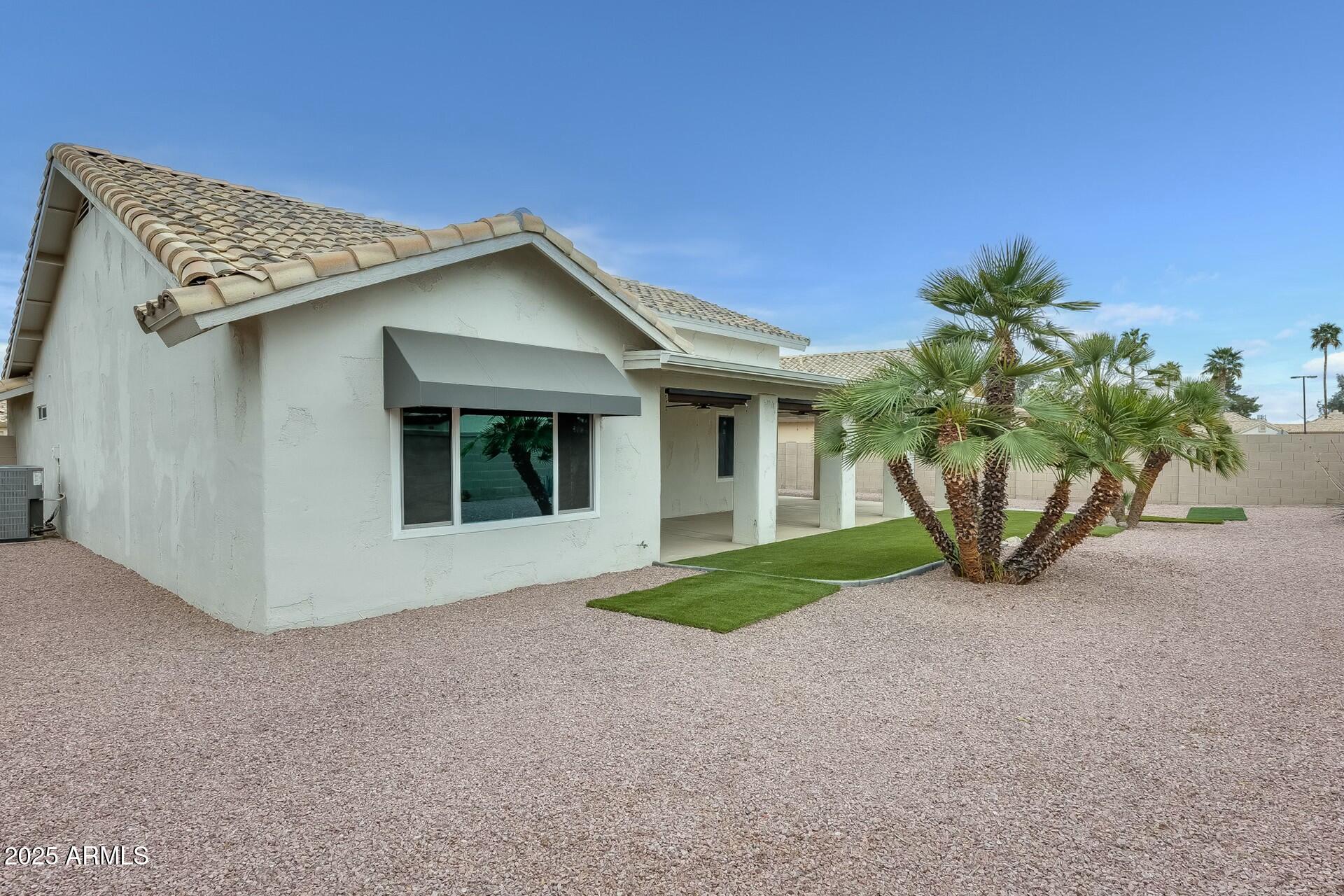 17514 North Rainbow Circle Surprise, AZ 85374 - Photo 42 of 69 a view of a house with a yard and potted plants