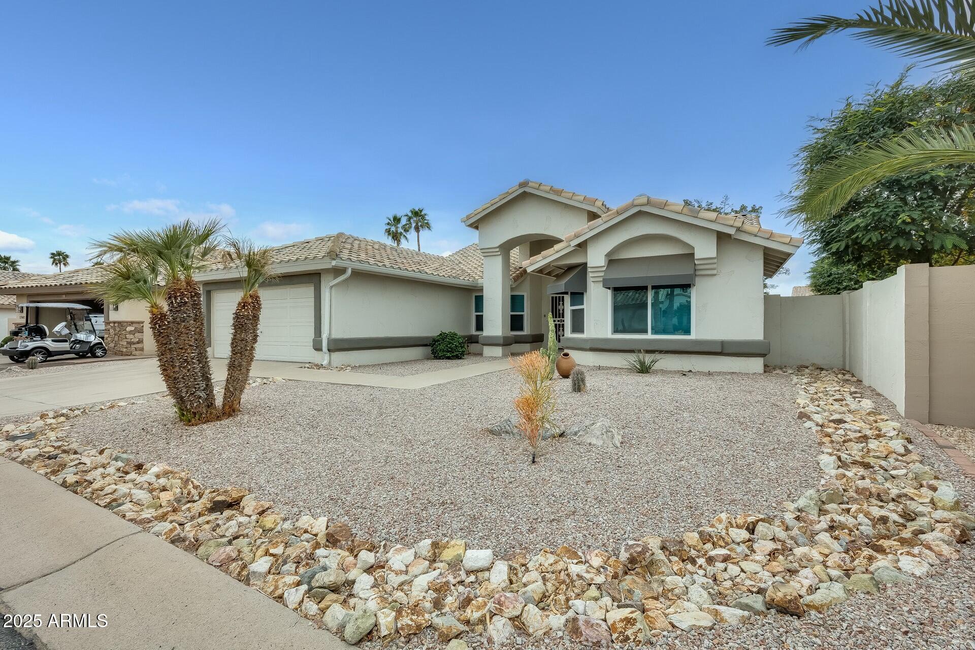17514 North Rainbow Circle Surprise, AZ 85374 - Photo 46 of 69 a front view of a house with a yard