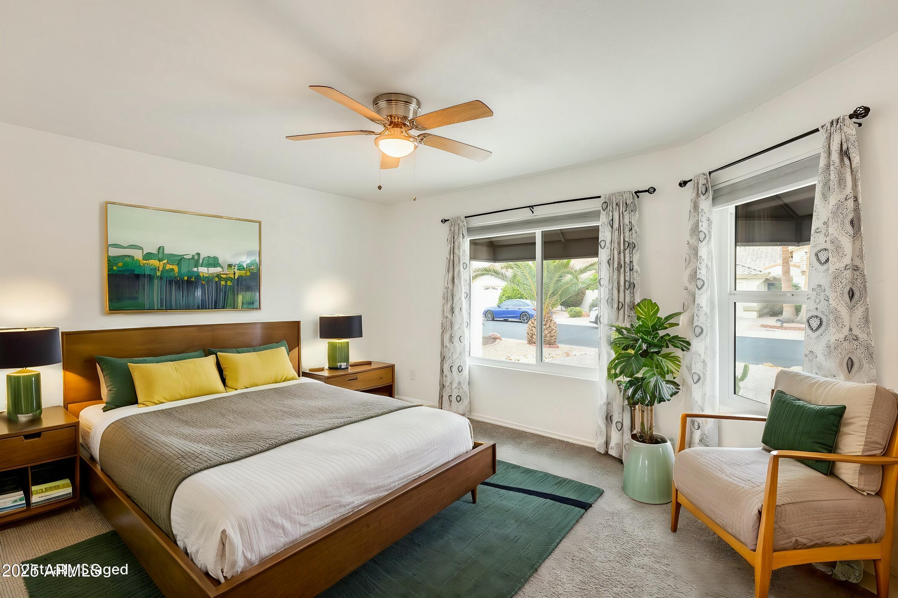 17514 North Rainbow Circle Surprise, AZ 85374 - Photo 6 of 69 a bedroom with a large bed and a couch