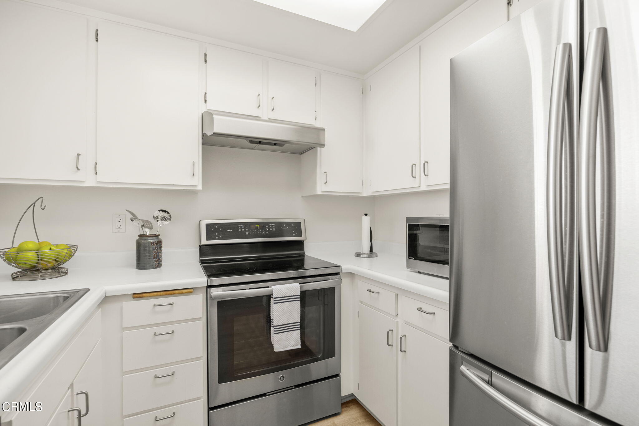 3140 Sunset Lane Oxnard, CA 93035 - Photo 17 of 45 a kitchen with white cabinets and white appliances