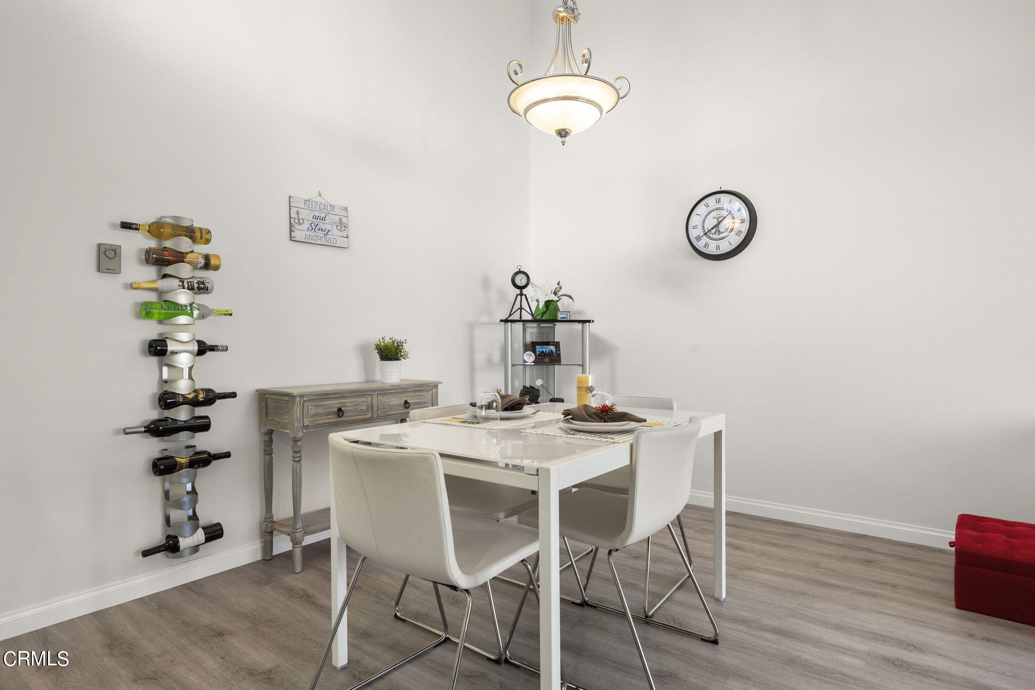 3140 Sunset Lane Oxnard, CA 93035 - Photo 7 of 45 a view of a dining room with furniture a chandelier and wooden floor