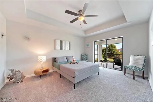 a bedroom with a bed a couch and a chandelier