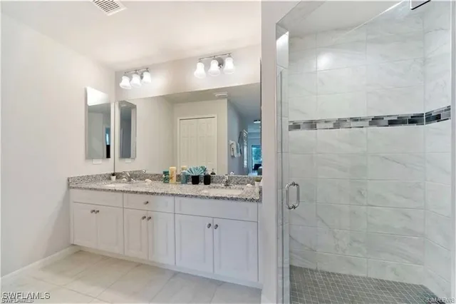 a bathroom with a double vanity sink and mirror