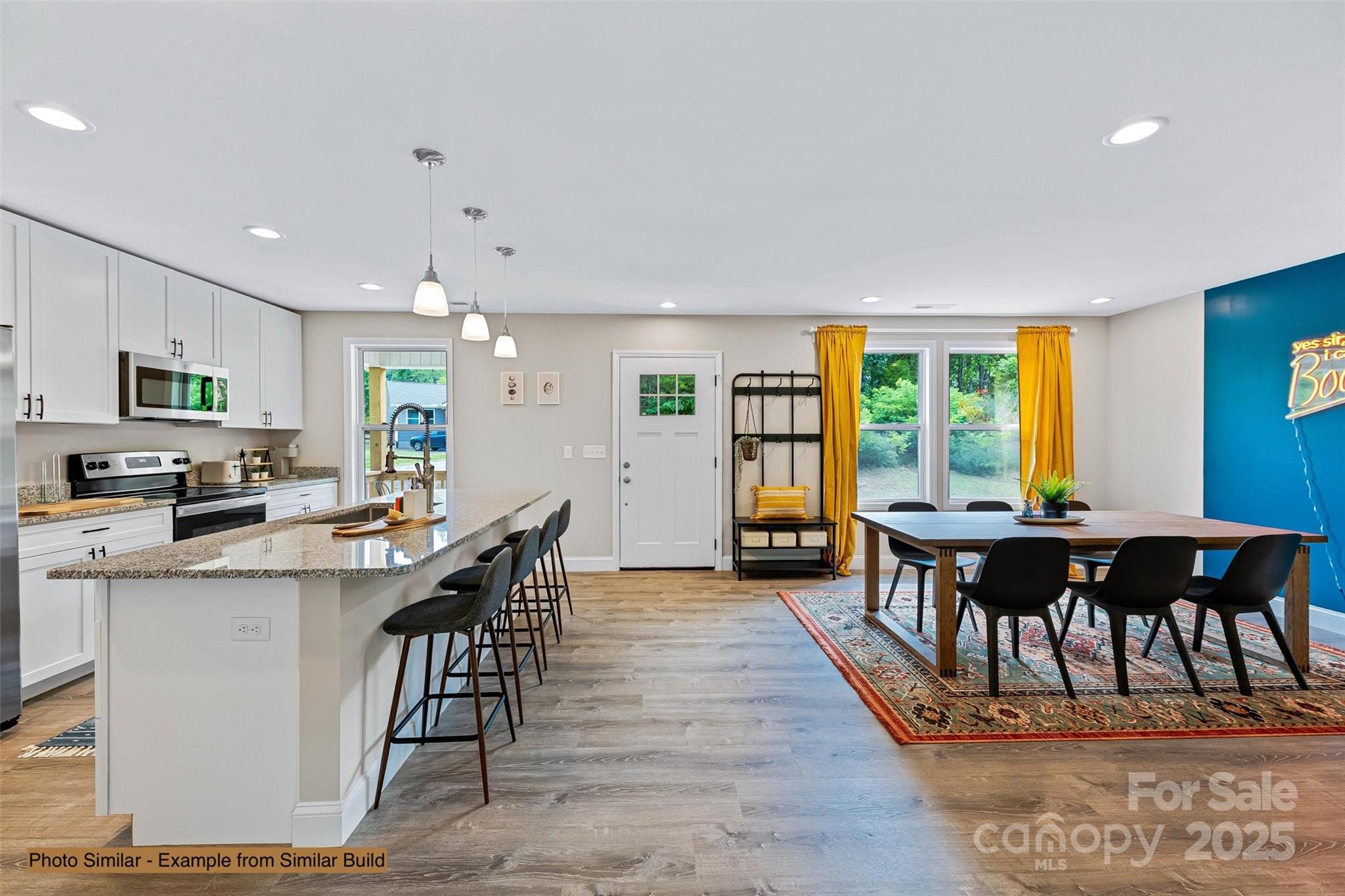 22 Hoyle Street Marion, NC 28752 - Photo 23 of 43 a kitchen with stainless steel appliances kitchen island granite countertop a dining table chairs and granite counter tops