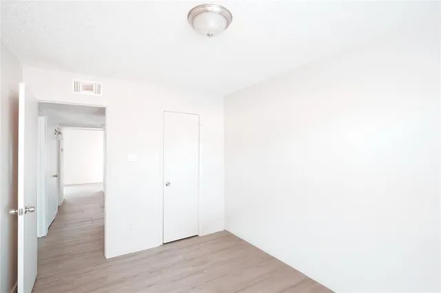 a view of a room with wooden floor