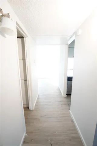 a view of a room with wooden floor and brick wall