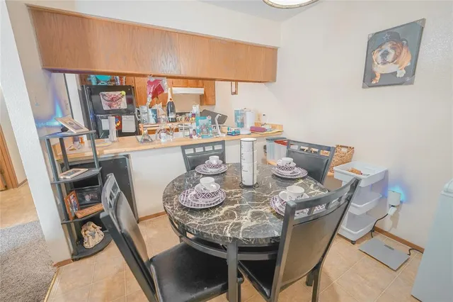 a dining room with furniture and a window