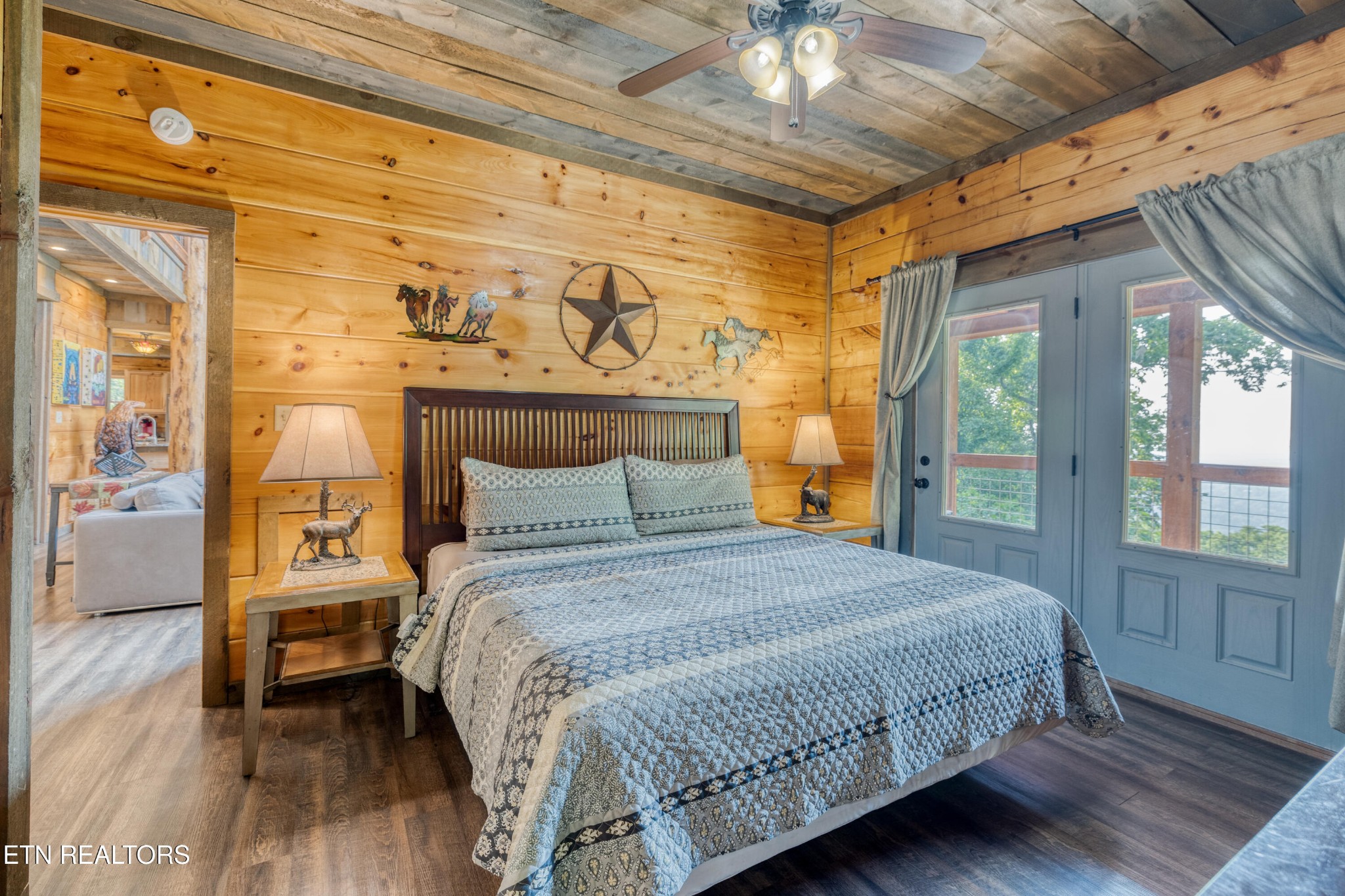 809 Pinecrest Way Sevierville, TN 37862 - Photo 19 of 60 a bedroom with a bed and wooden floor