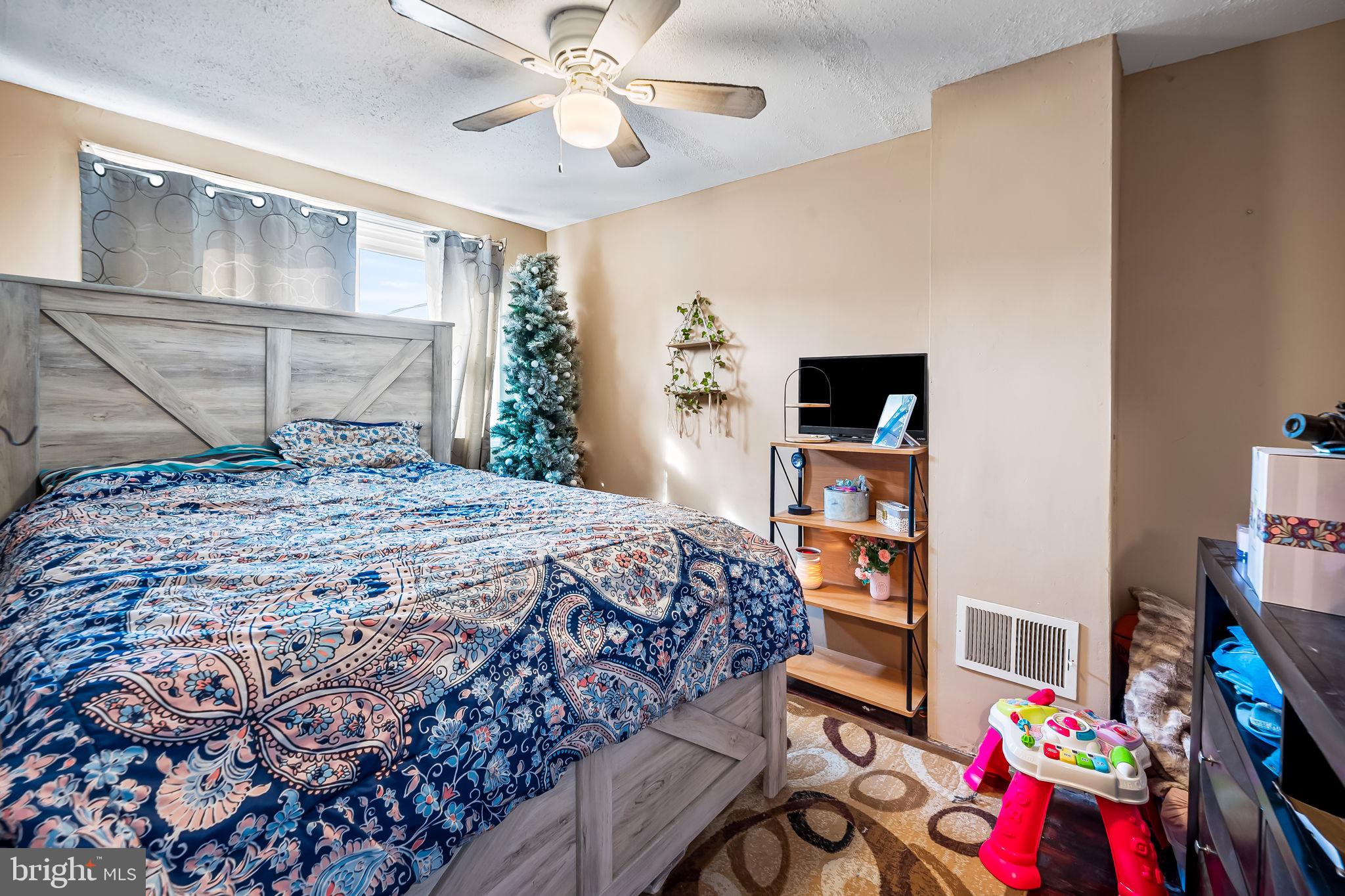 229 Arden Road West Baltimore, MD 21225 - Photo 14 of 17 a bedroom with a bed and a chandelier