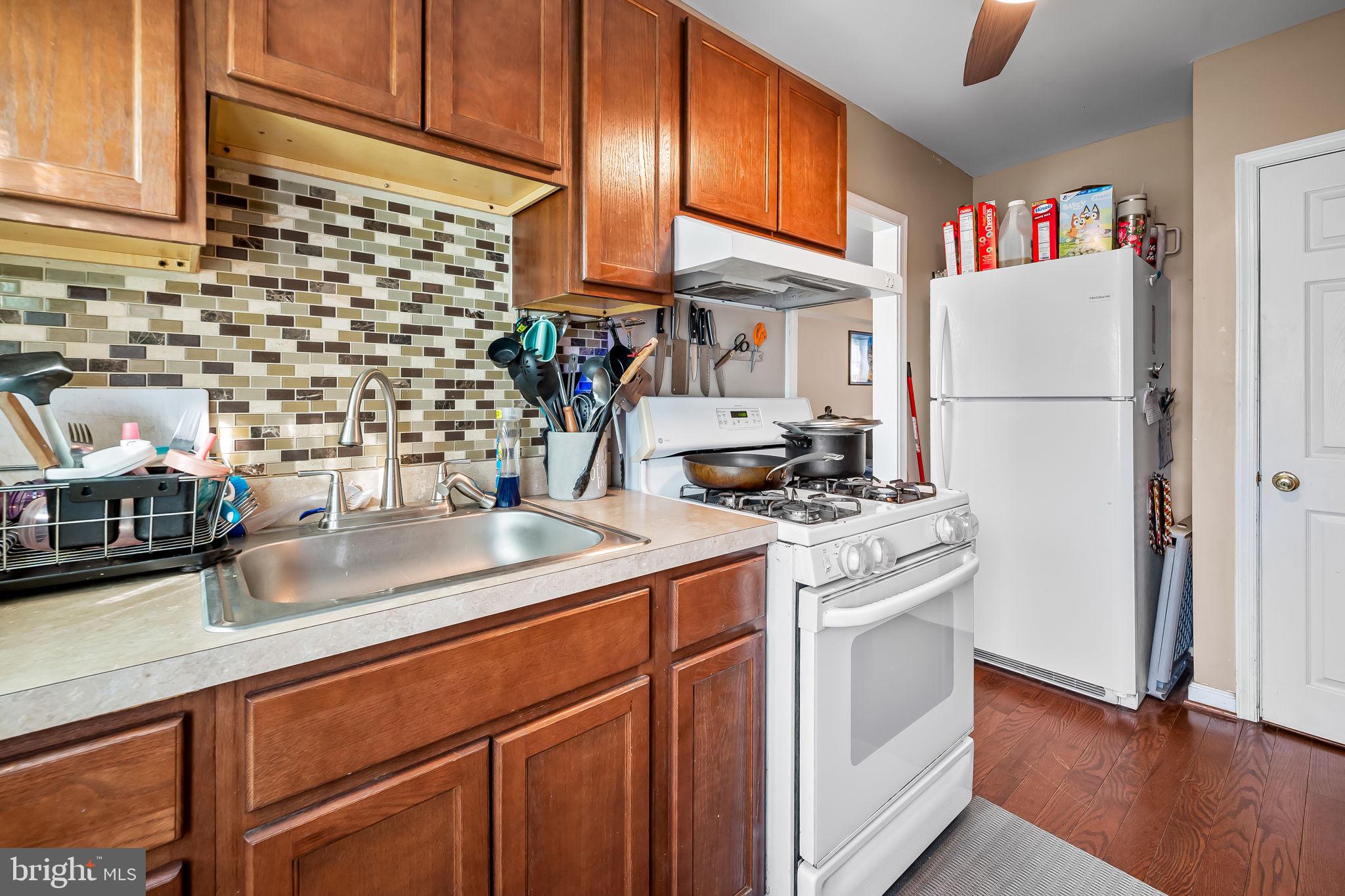 229 Arden Road West Baltimore, MD 21225 - Photo 8 of 17 a kitchen with stainless steel appliances a sink and a refrigerator
