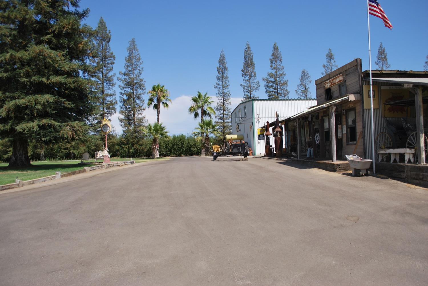 41261B Road 40 Reedley, CA 93654 - Photo 14 of 46 Main driveway to the home. The two buildings in the photo belong to the neighbor.