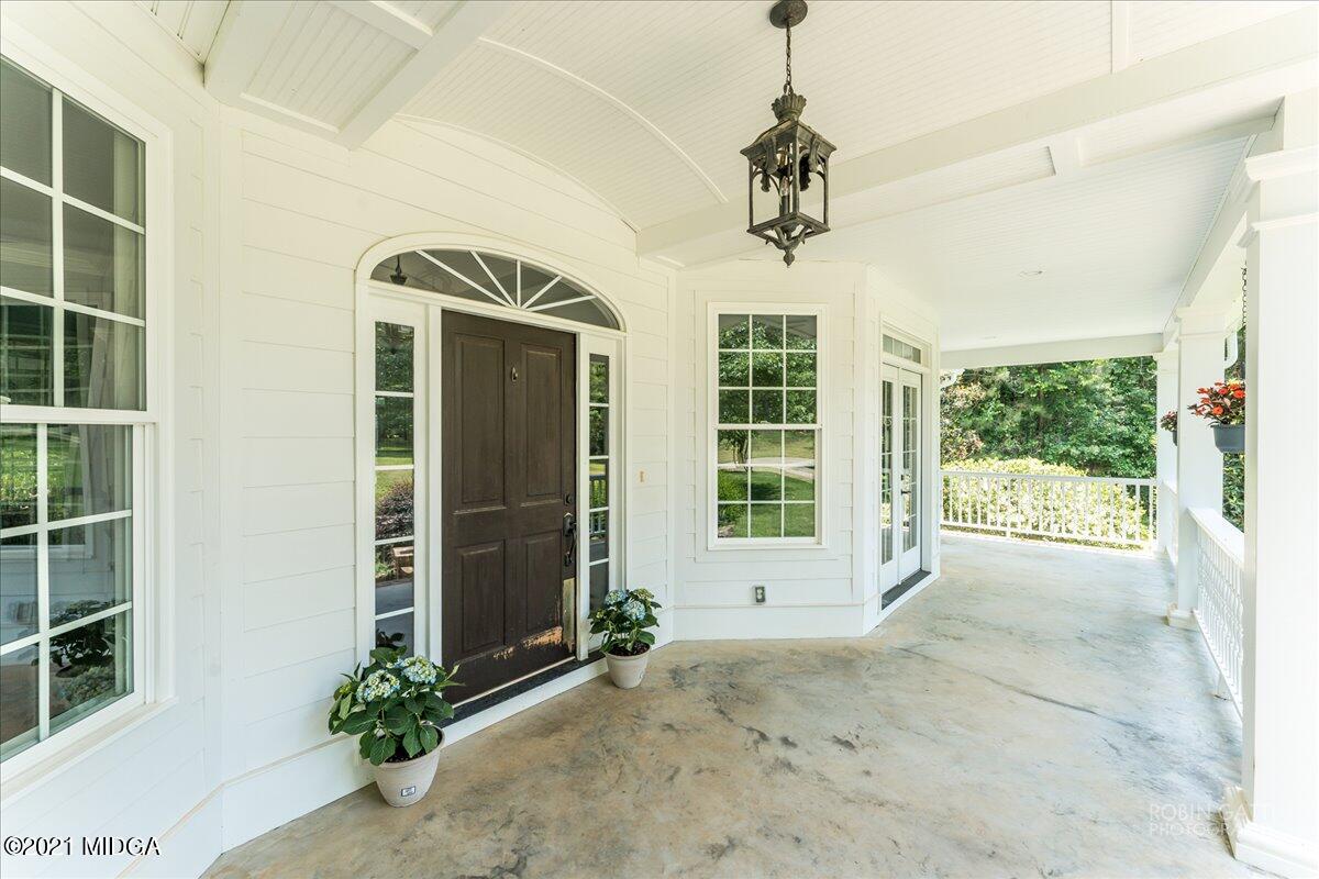 908 Jenkins Road Forsyth, GA 31029 - Photo 3 of 34 a view of a hallway with windows and chandelier
