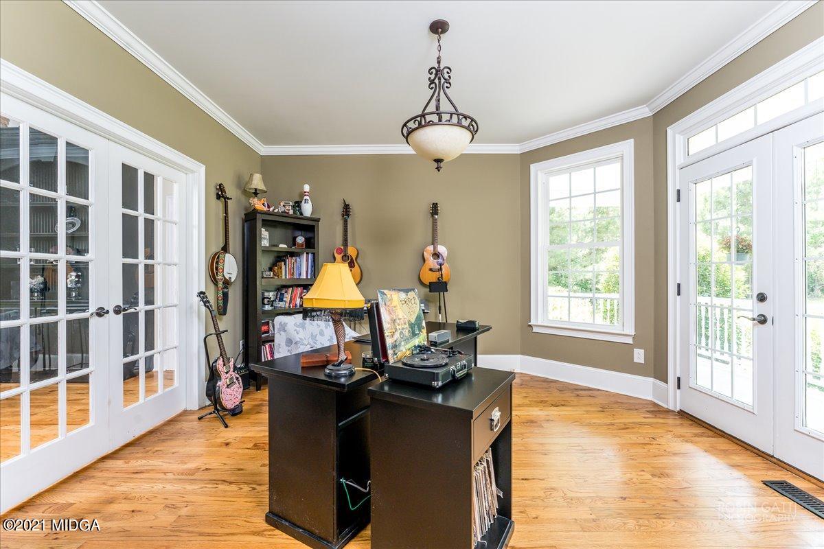 908 Jenkins Road Forsyth, GA 31029 - Photo 8 of 34 a living room filled with furniture hardwood floor and a chandelier