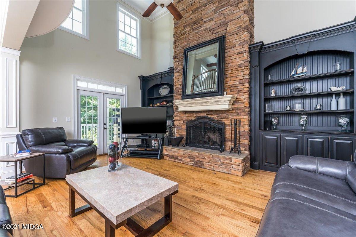 908 Jenkins Road Forsyth, GA 31029 - Photo 9 of 34 a living room with furniture and a fireplace