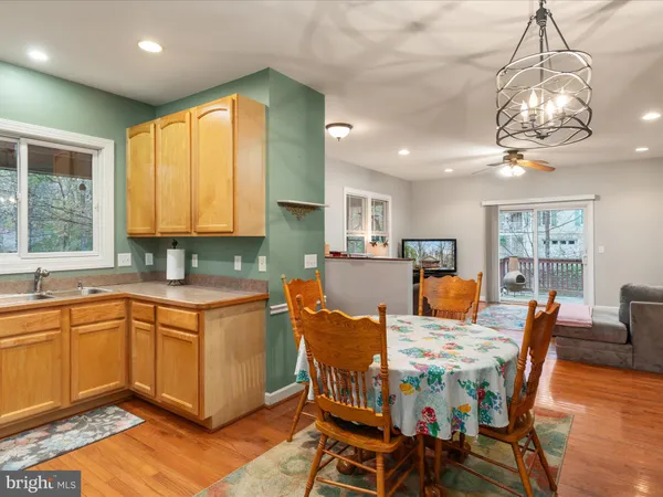 a view of a dining room with furniture a chandelier and wooden floor