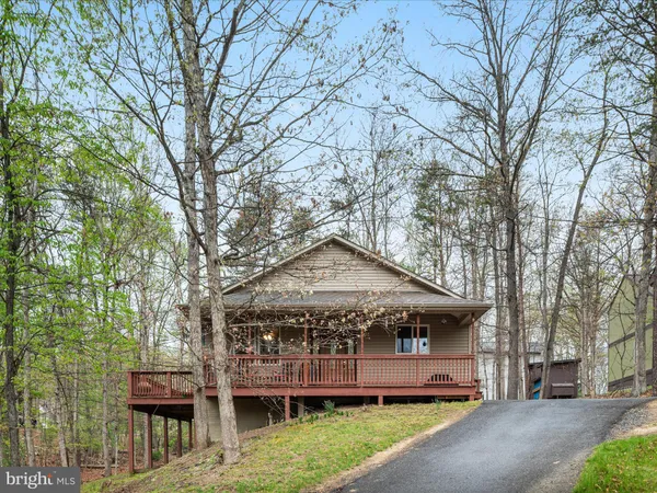 a front view of a house with a garden and fountain