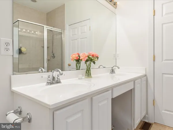 a bathroom with a tub a sink and a shower
