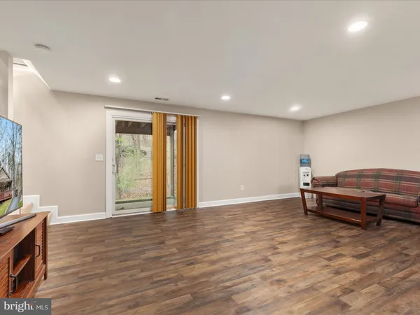 a living room with a couch and a table with wooden floor