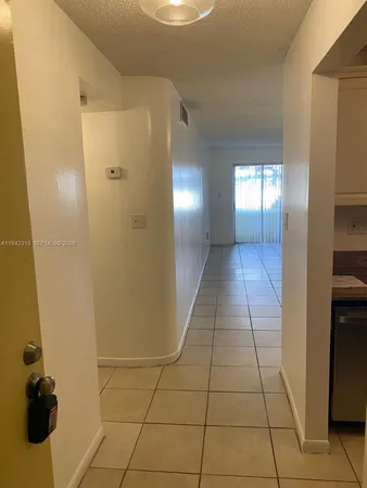 a view of hallway with a window and a mirror