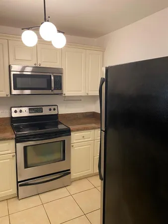 a kitchen with a stove and a microwave